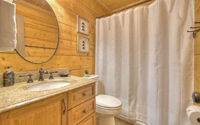 bathroom featuring wooden walls, curtained shower, toilet, and vanity