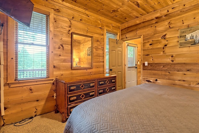 bedroom with carpet floors, wooden walls, and wooden ceiling