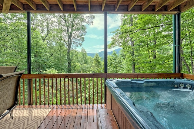 unfurnished sunroom with a forest view