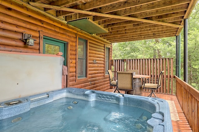 wooden terrace featuring a hot tub