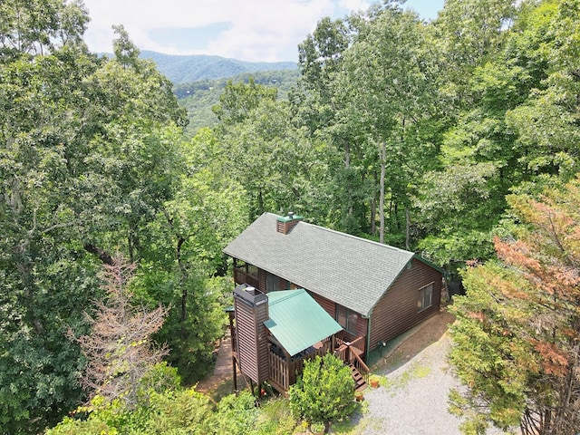 birds eye view of property with a mountain view and a forest view