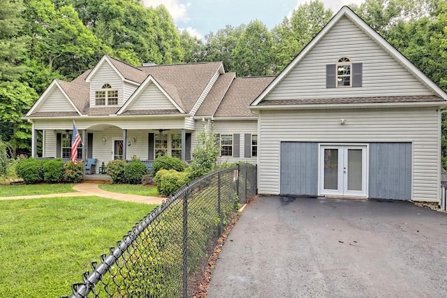 view of front of property featuring covered porch, a front yard, and french doors