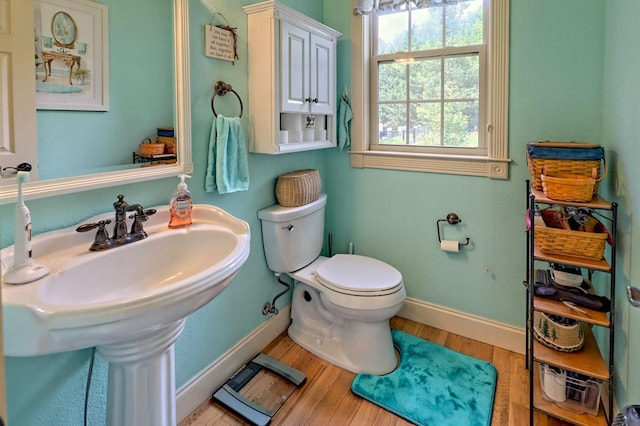 bathroom featuring hardwood / wood-style flooring, toilet, and sink