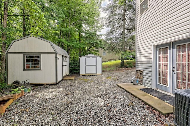 view of yard with central AC and a storage unit