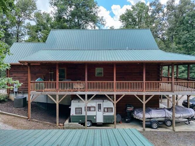 rear view of property featuring central air condition unit and a deck