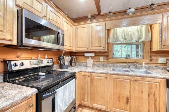 kitchen featuring light brown cabinets, sink, and electric range oven