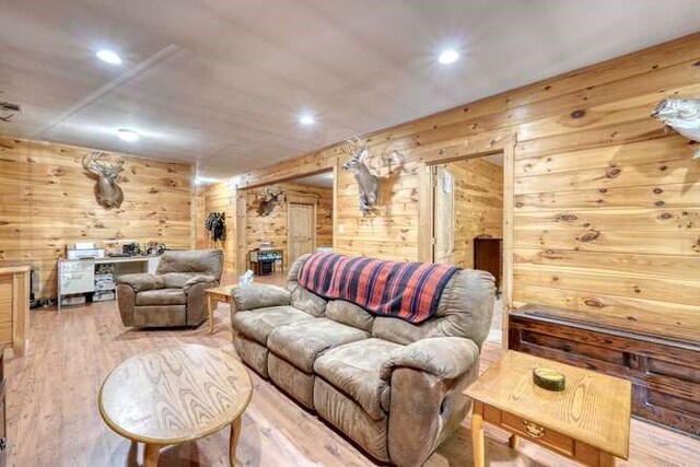 living room with wood walls and hardwood / wood-style floors