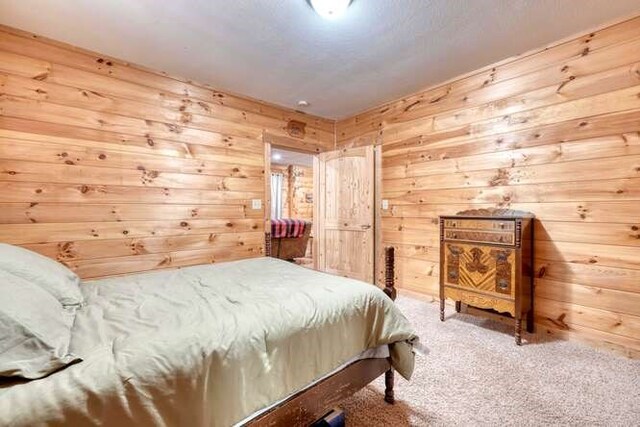 carpeted bedroom with wooden walls