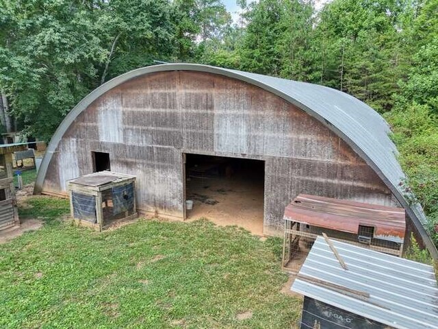 view of outbuilding featuring a lawn