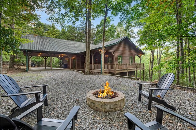 view of community with a fire pit and a patio