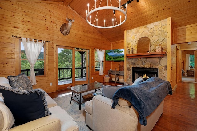 living room with hardwood / wood-style flooring, wooden walls, and high vaulted ceiling