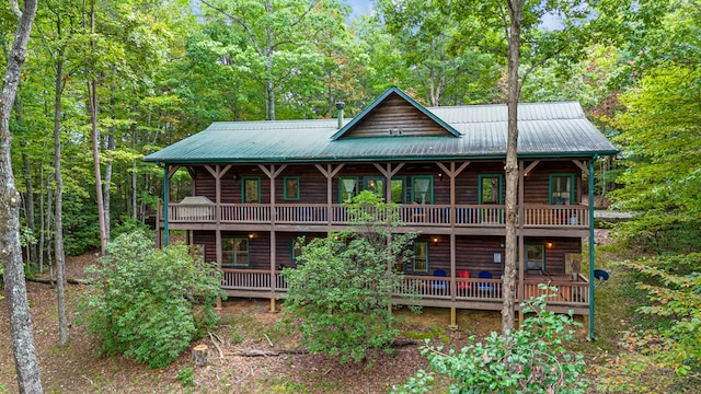 back of house featuring a wooden deck