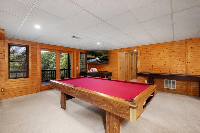 recreation room featuring a paneled ceiling, billiards, wood walls, and french doors