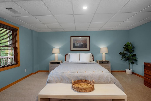 carpeted bedroom featuring a paneled ceiling