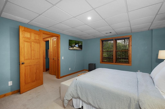 carpeted bedroom with a paneled ceiling