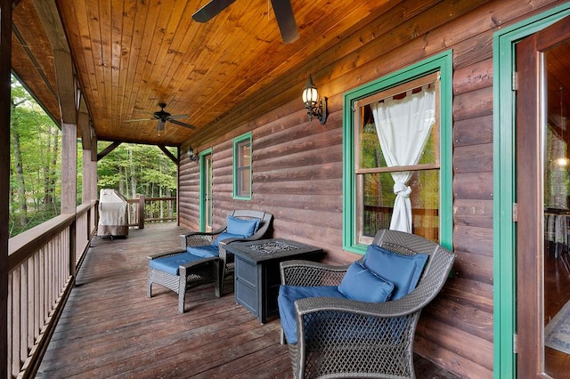 wooden terrace with ceiling fan and a porch