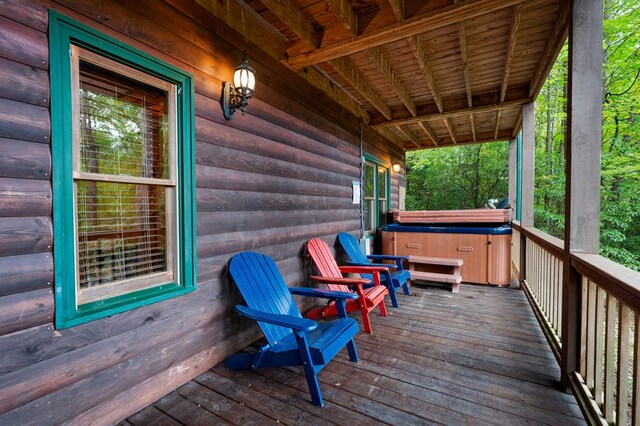 wooden terrace featuring a hot tub