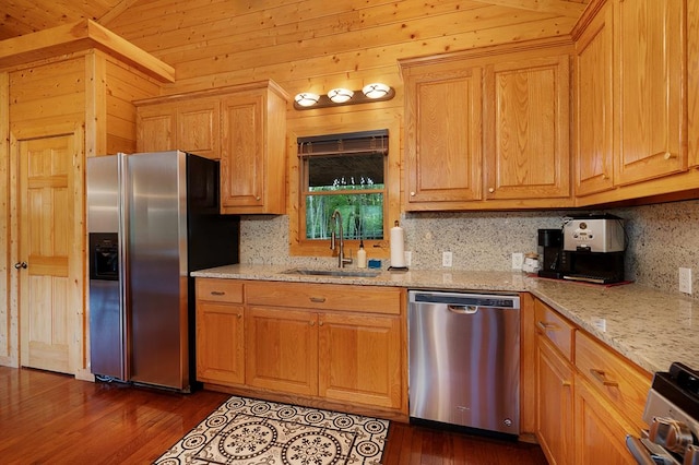 kitchen with wood ceiling, wooden walls, appliances with stainless steel finishes, light stone countertops, and dark hardwood / wood-style flooring