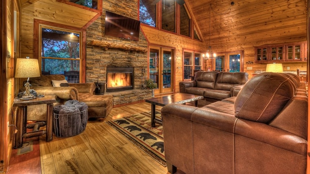 living room featuring high vaulted ceiling, hardwood / wood-style floors, wooden ceiling, and a fireplace