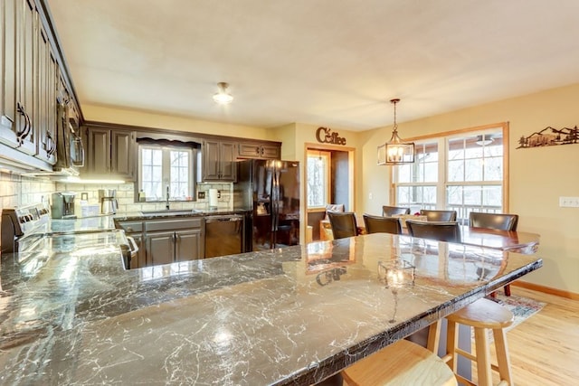 38 Smoky Mtn Rdg, Marble, NC 28905 - kitchen with stainless steel appliances, a sink, dark stone counters, decorative backsplash, and a peninsula