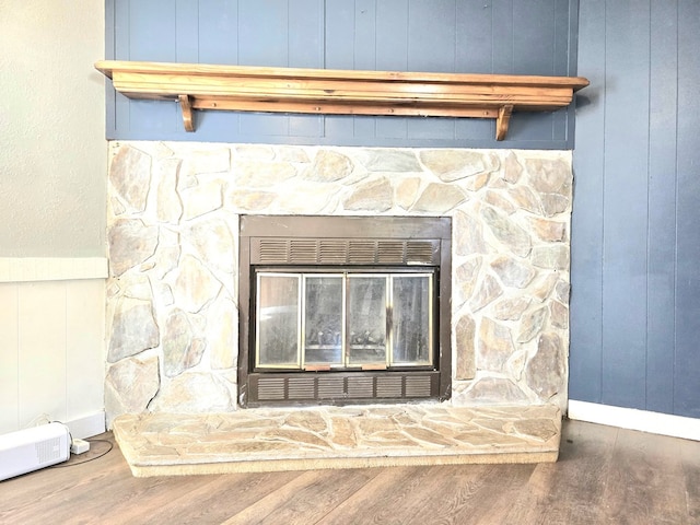 details with wood walls, a fireplace, and hardwood / wood-style flooring