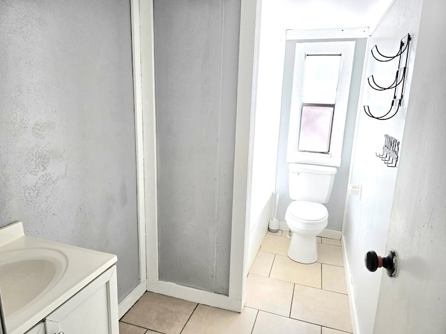 bathroom featuring tile patterned flooring, vanity, and toilet