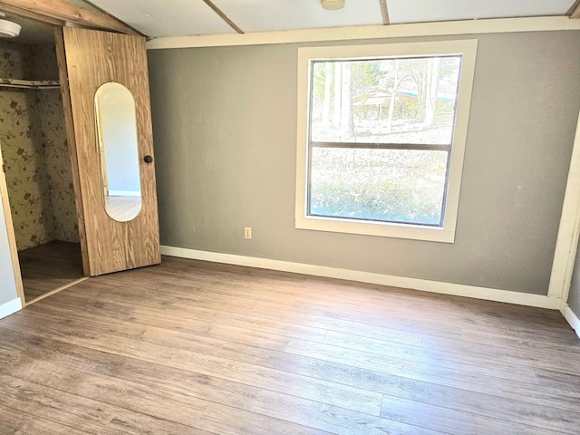 unfurnished bedroom with light hardwood / wood-style floors and a closet