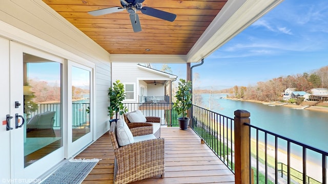 balcony with ceiling fan and a water view