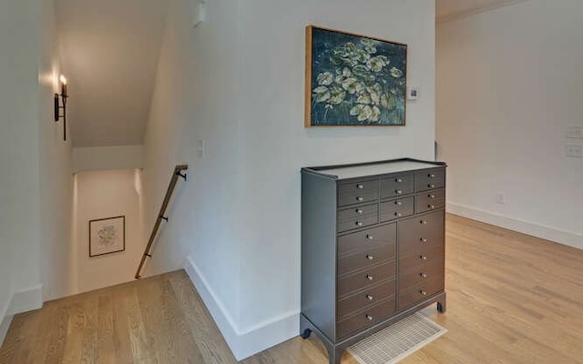 stairs featuring hardwood / wood-style floors