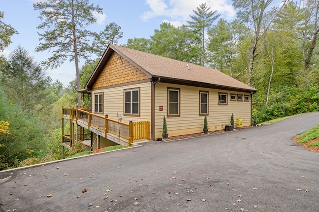 view of home's exterior with a wooden deck