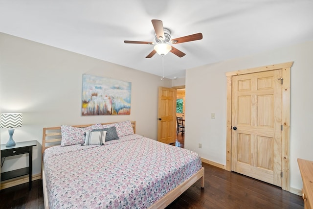 bedroom with dark wood-type flooring and ceiling fan