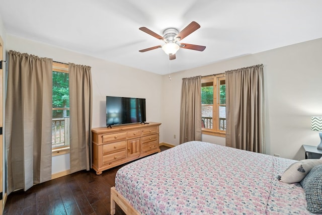 bedroom with ceiling fan, dark hardwood / wood-style floors, and multiple windows