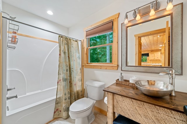 full bathroom with toilet, vanity, and shower / bathtub combination with curtain