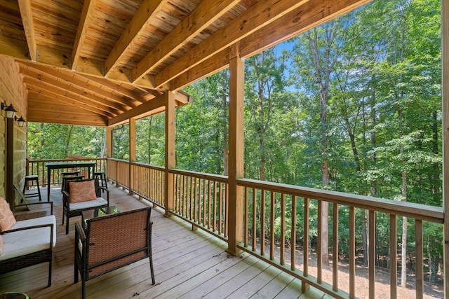 wooden deck with an outdoor living space