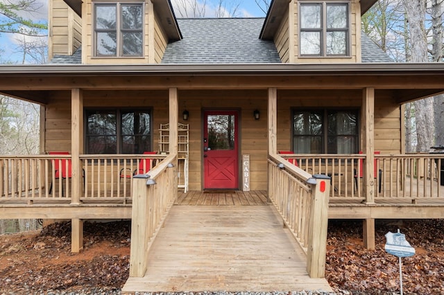 view of exterior entry featuring covered porch