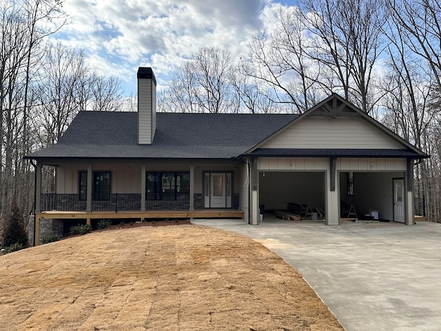 57 Fairview Trl, Morganton, GA 30560 - view of front of home with a garage, a chimney, board and batten siding, concrete driveway, and a porch