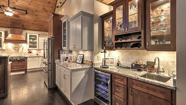 interior space with premium range hood, a sink, wine cooler, wooden ceiling, and appliances with stainless steel finishes