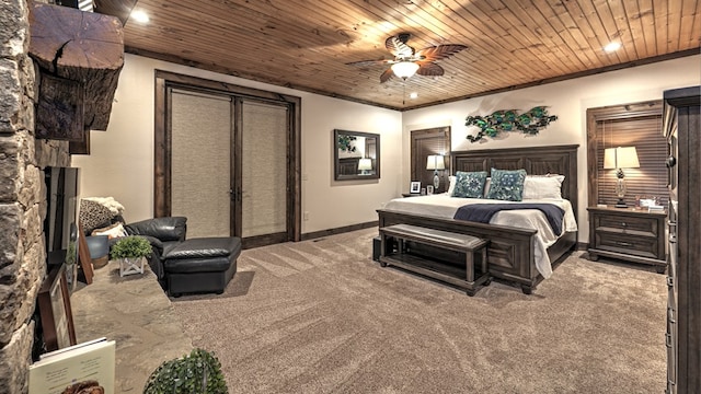 bedroom featuring ceiling fan, carpet floors, wood ceiling, baseboards, and a stone fireplace