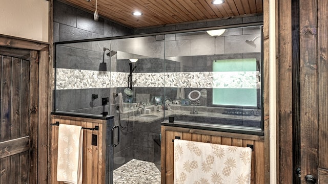 full bathroom featuring a sink, wood ceiling, a shower stall, and recessed lighting