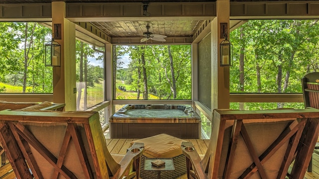sunroom / solarium with ceiling fan and a jacuzzi