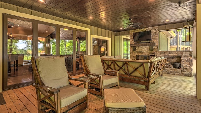 wooden deck with an outdoor living space with a fireplace, french doors, and a ceiling fan