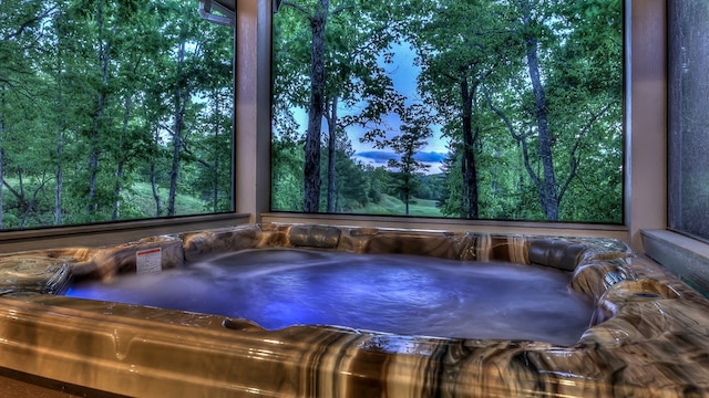 exterior space featuring an outdoor hot tub