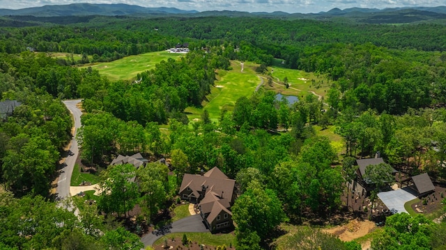 birds eye view of property featuring a water and mountain view and a wooded view