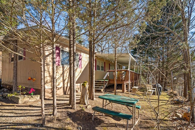 back of house with a wooden deck