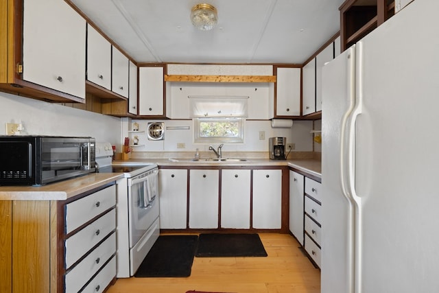 kitchen featuring white cabinetry, sink, white appliances, and light hardwood / wood-style flooring