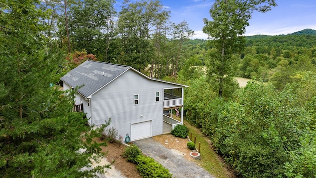 aerial view of property and surrounding area with a forest