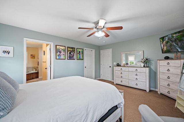 bedroom with ensuite bathroom, a ceiling fan, carpet, and baseboards