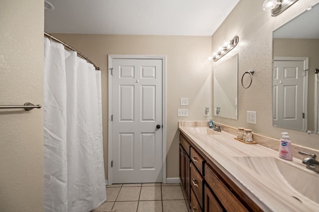 bathroom featuring tile patterned floors and double vanity