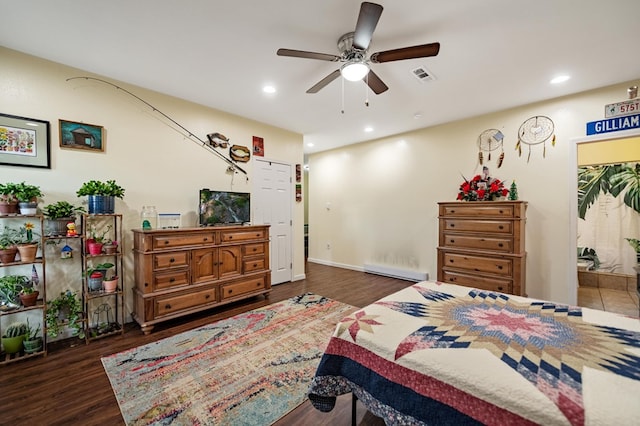 bedroom with a baseboard radiator, wood finished floors, recessed lighting, and a ceiling fan