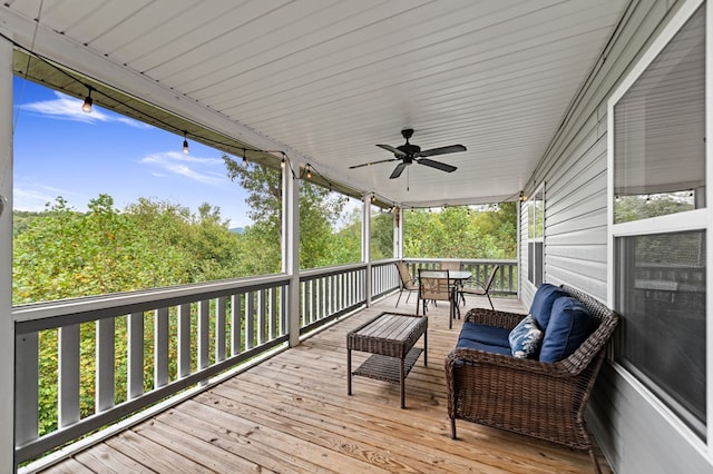 wooden terrace with ceiling fan and outdoor dining area